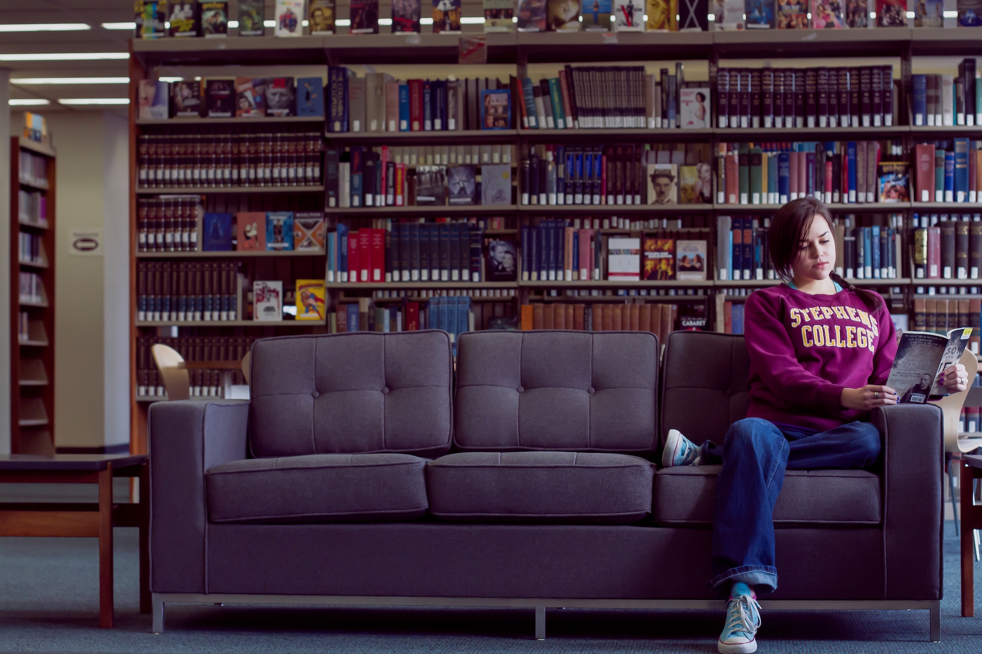 Student on a couch in the library.