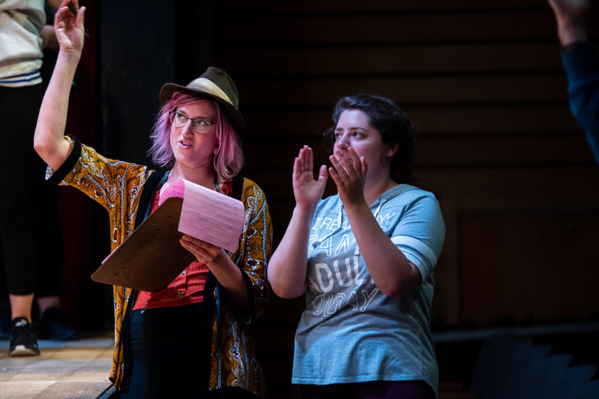 Student costume designers at work on the set of a production.