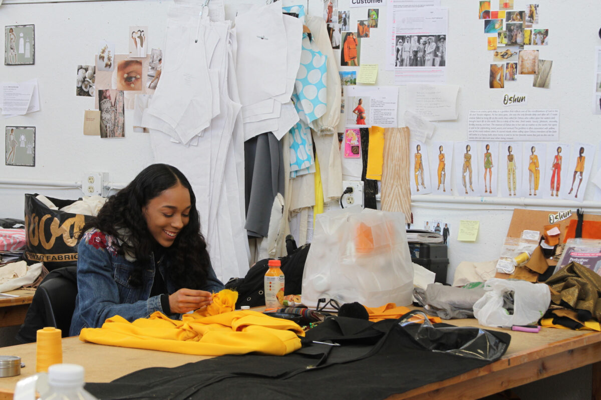 A fashion student works on her designs