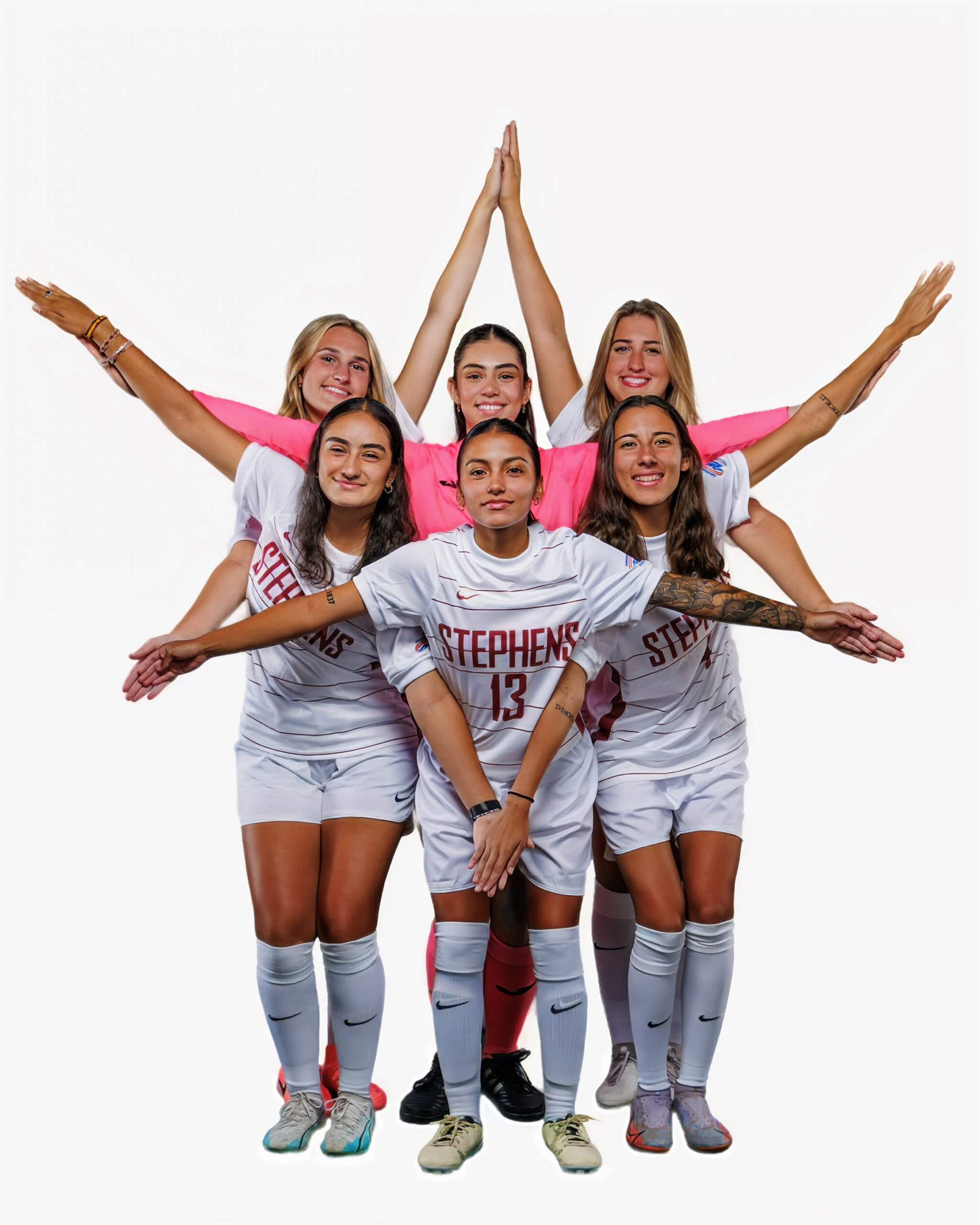 Soccer players forming a star with their arms