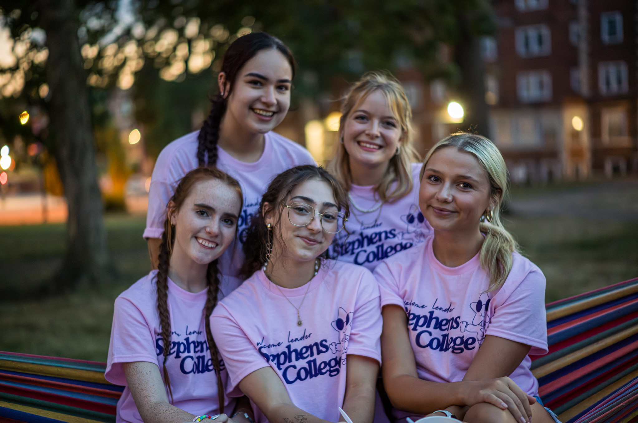 Five Welcome Leaders in pink Stephens shirts at dusk