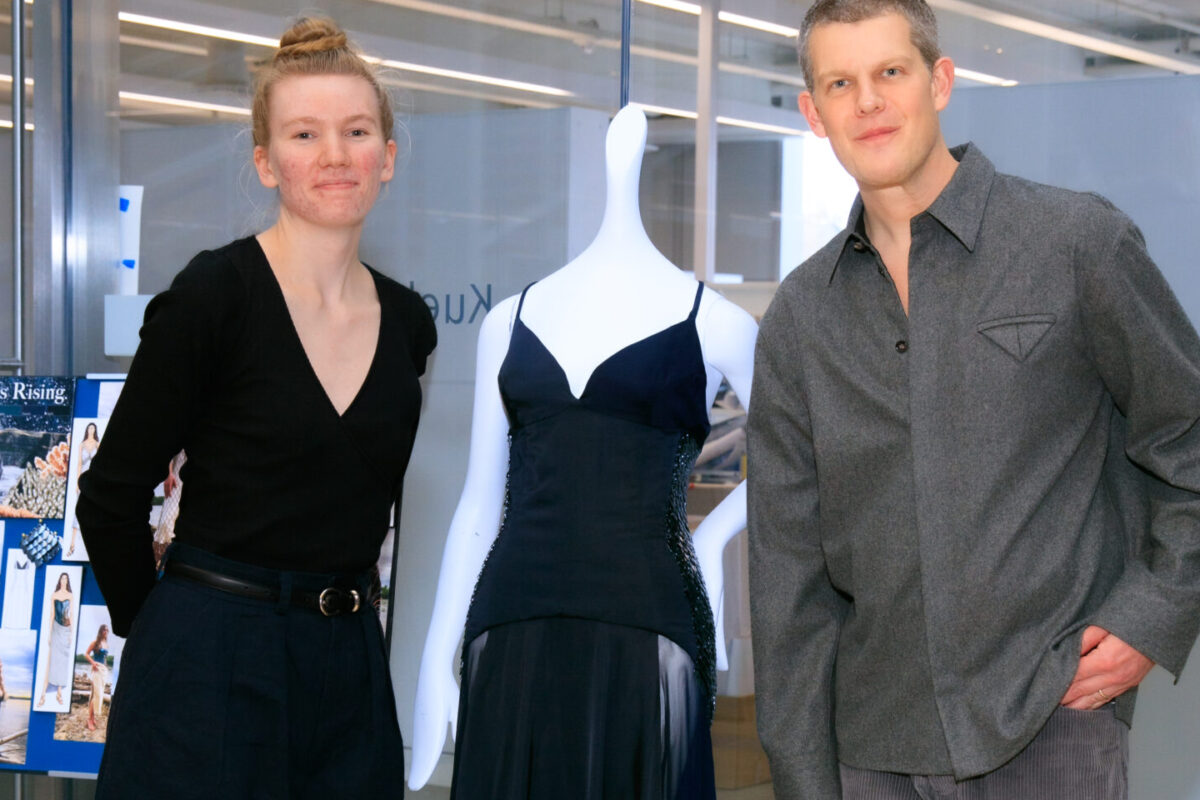 Julia League ’25 poses with her design and Wes Gordon.