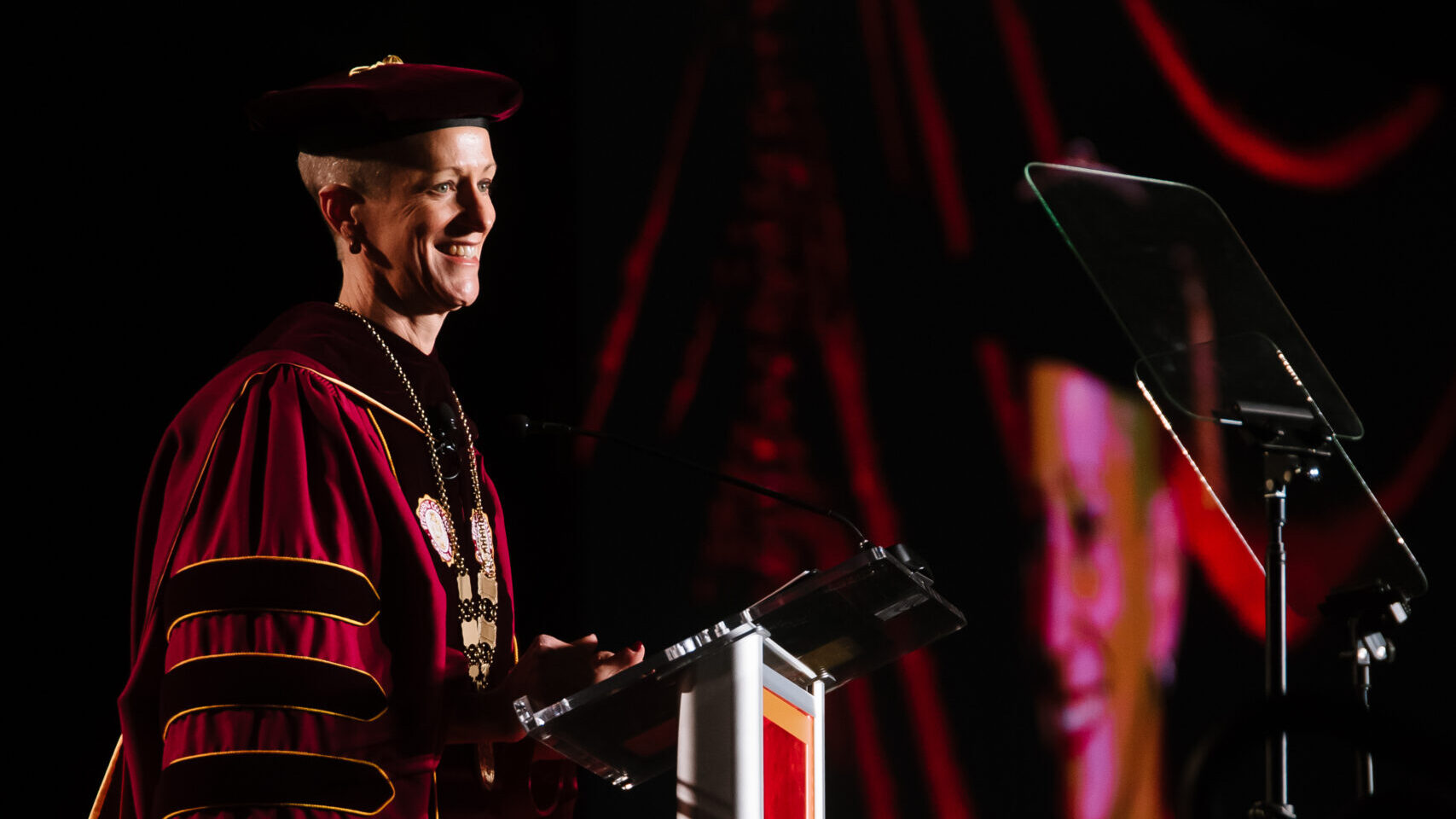 President Shannon B. Lundeen smiles at a podium during her Investiture Ceremony.