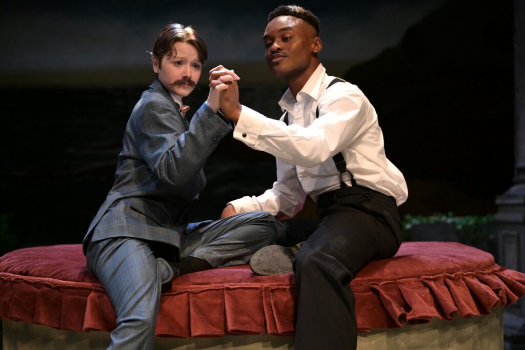Two students holding hands during an act in "Twelfth Night, or What You Will" by William Shakespeare.