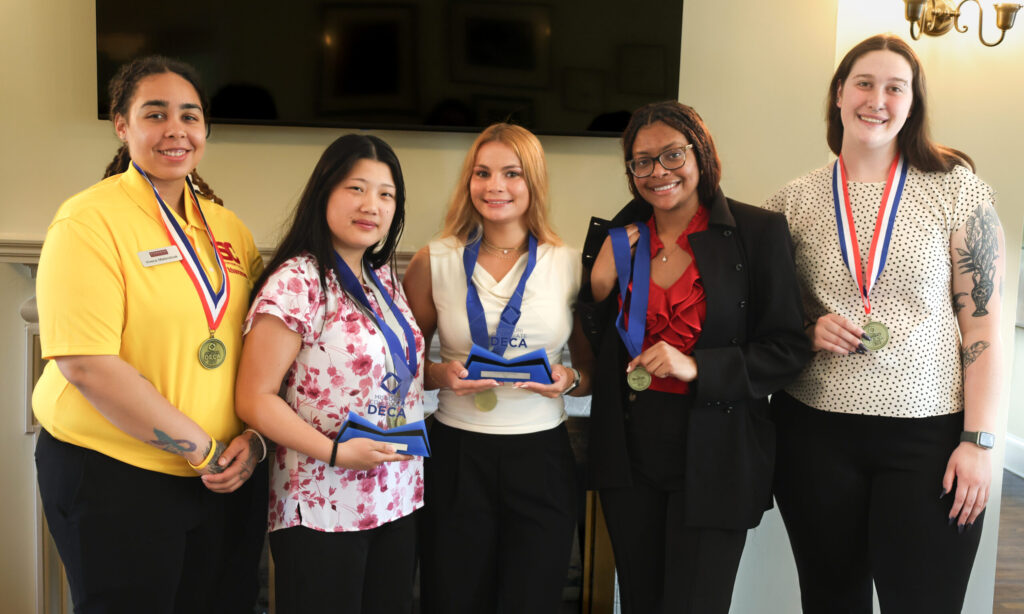 DECA Students smiling with their awards after the international competition.